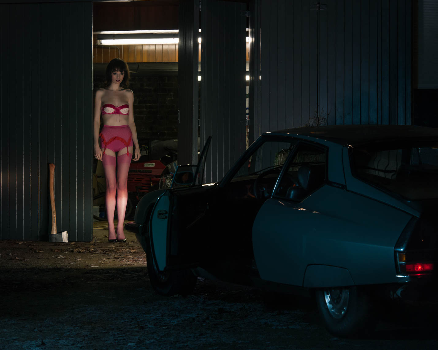 fashion model standing by a car dressed in lingerie photograph by marc rogoff