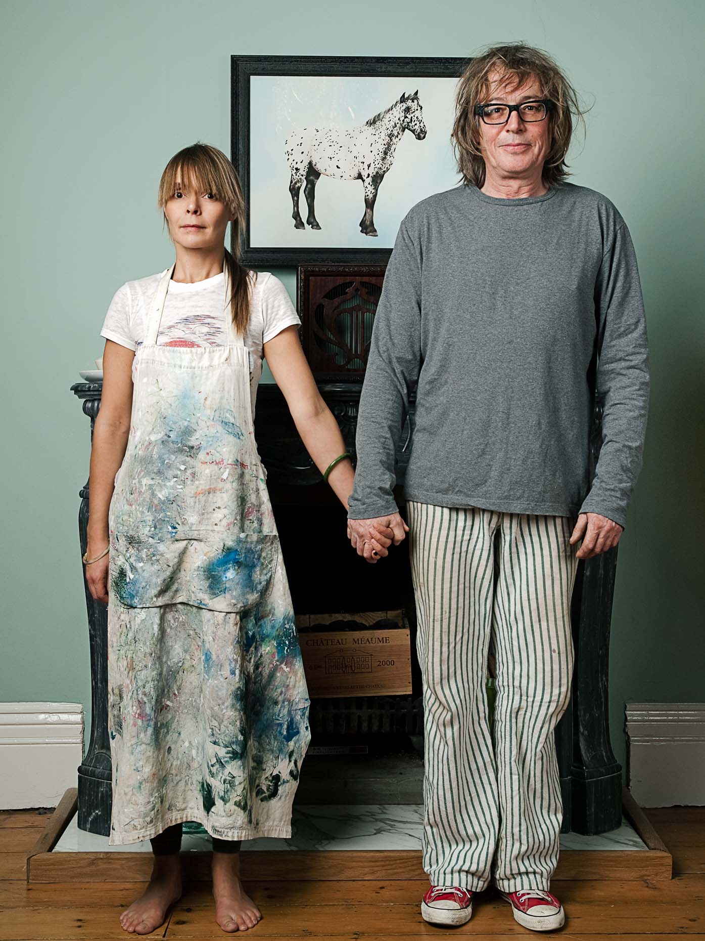 Photo of man and woman holding hands in a living room photographed by Marc Rogoff
