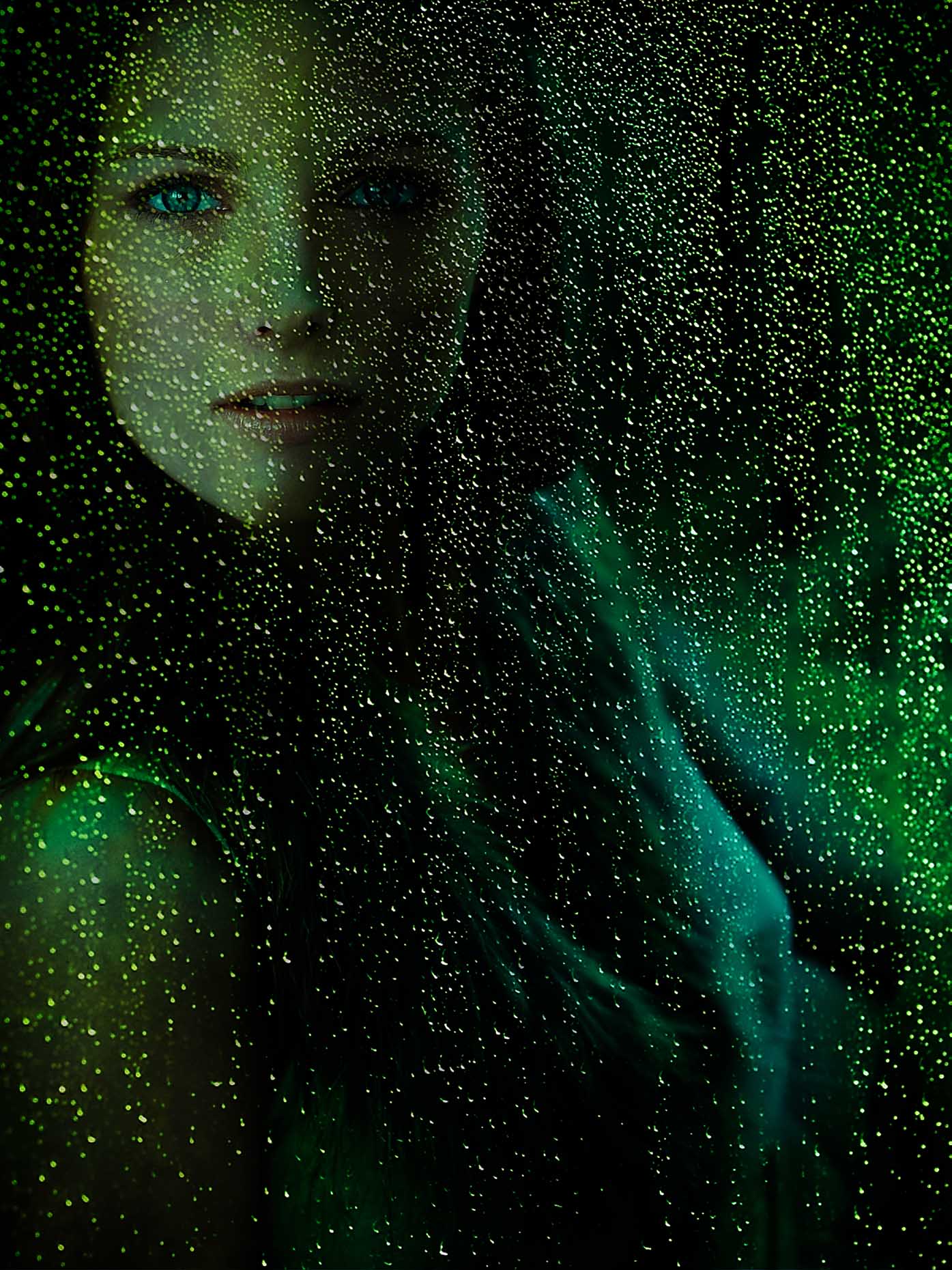 Female model behind green tinted glass with water droplets photographed by Marc Rogoff